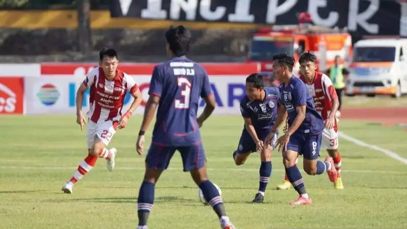 Pemain nomor punggung 22 Persis Sutanto Tan (kostum merah putih) saat menghadang serangan beberapa pemain Arema FC (kostumbiru biru) dalam Liga 1.