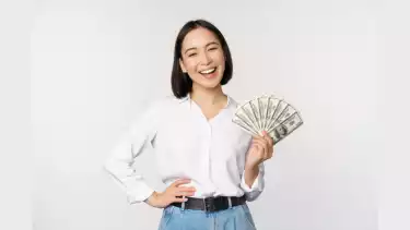 Wanita Asia memegang uang