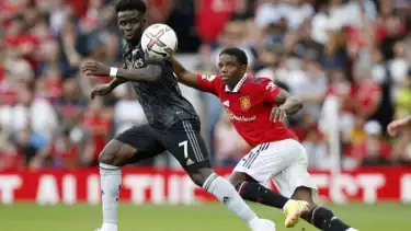 Pesepak bola Arsenal Bukayo Saka i(kiri) berebut bola dengan pesepak bola pesepak bola Manchester United Tyrell Malacia dalam laga lanjutan Liga Inggris, di Stadion Old Trafford, Manchester, Inggris, Minggu (4/9/2022)