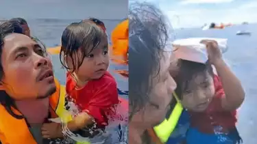 Abdul Rahman Agu saat menolong anak kecil korban insiden terbakarnya Kapal KM Barcelona V