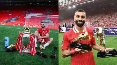 Mohamed Salah berpose dengan deretan trofi yang diraihnya bersama Liverpool.