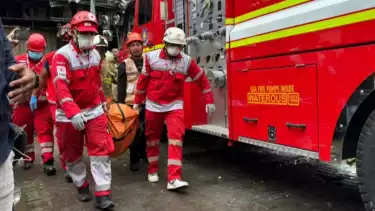 Petugas saat mengevakuasi jenazah korban kebakaran gedung Terra Drone di Kemayoran, Jakarta Pusat, Selasa (9/12/2025).