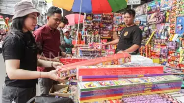 Pedagang melayani pembeli kembang api di Pasar Asemka, Jakarta, Selasa (17/12/2024).